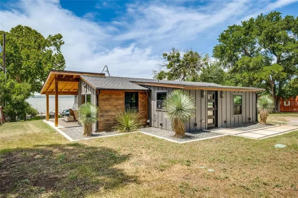 a front view of a house with a yard outdoor seating