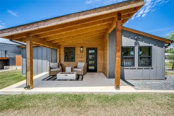 a view of a house with backyard porch and sitting area