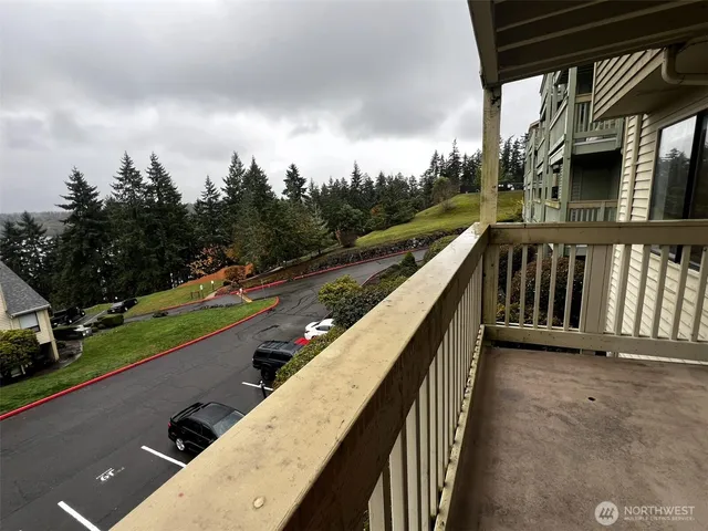 a view of balcony with wooden floor and fence