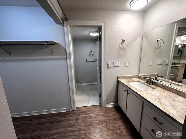 a view of a room with wooden floor and window