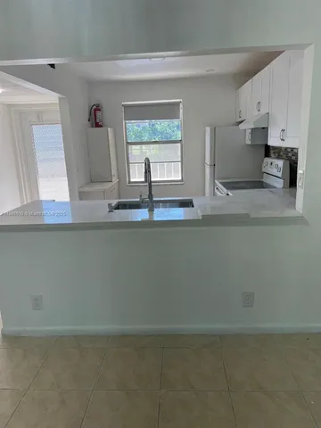 a view of kitchen with cabinets