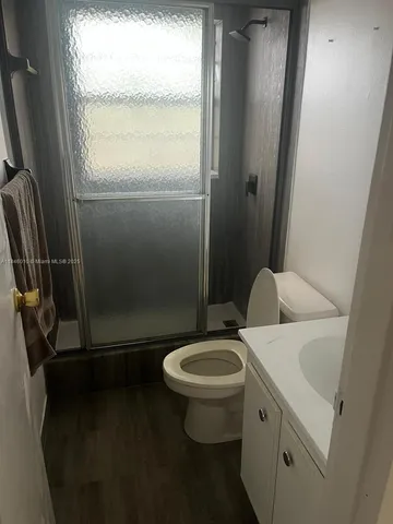a view of wooden floor and windows in a room