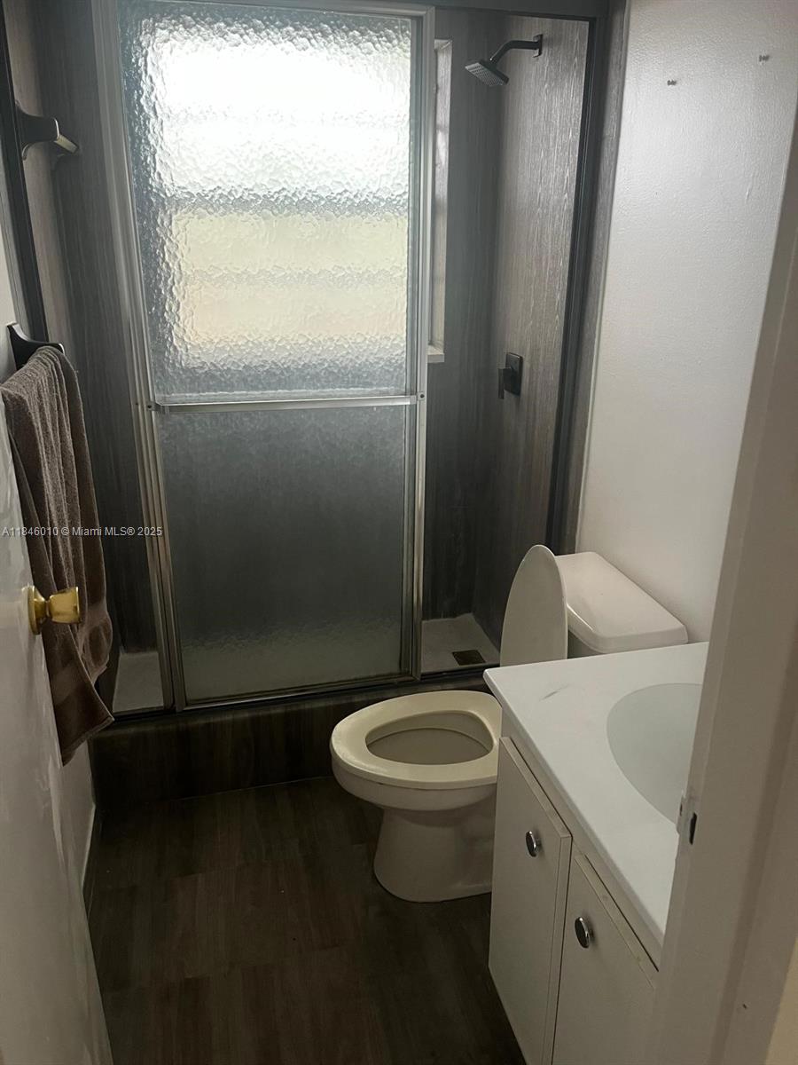 1015 Country Club Drive, Unit 302 Margate, FL 33063 - Photo 7 of 9 a bathroom with a sink toilet and shower