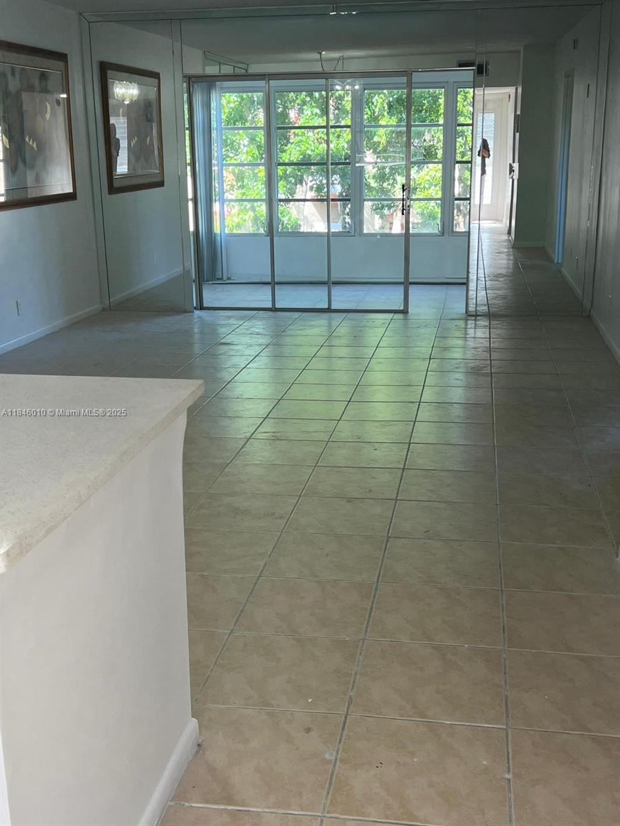 1015 Country Club Drive, Unit 302 Margate, FL 33063 - Photo 8 of 9 a view of wooden floor and windows in a room