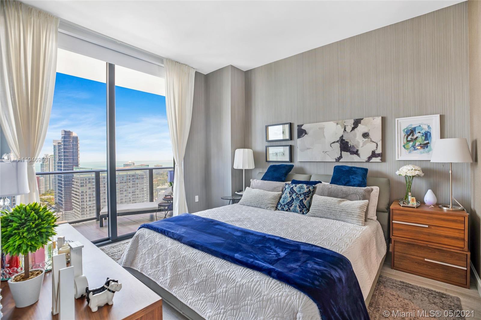 45 Southwest 9th Street, Unit 4204 Miami, FL 33130 - Photo 10 of 66 a bedroom with a balcony a bed and a potted plant