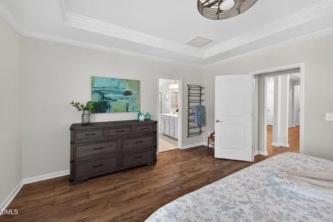a room with a bed and a dresser