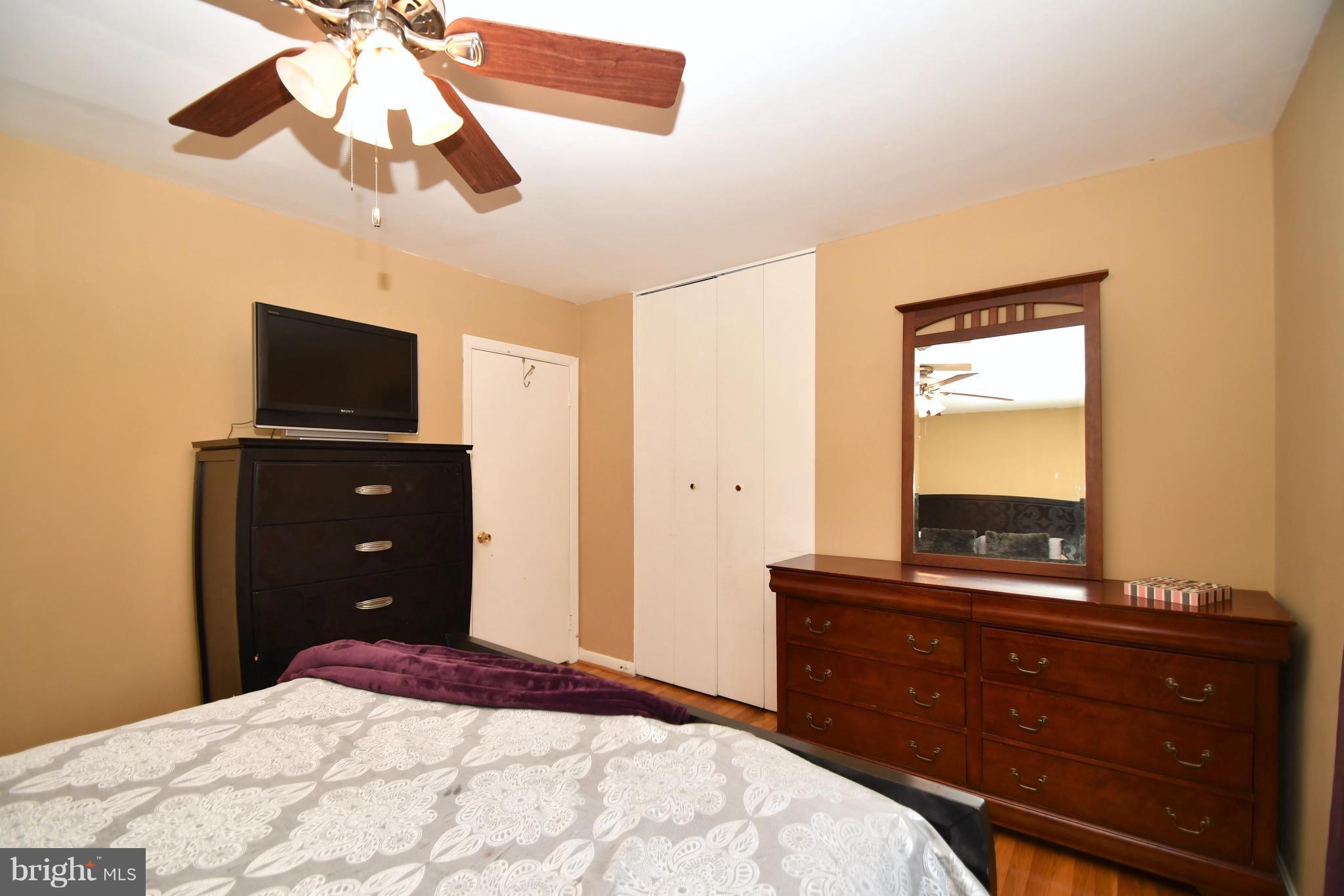 6102 Chanceford Road Baltimore, MD 21228 - Photo 14 of 30 a bedroom with a bed and a mirror on the dresser