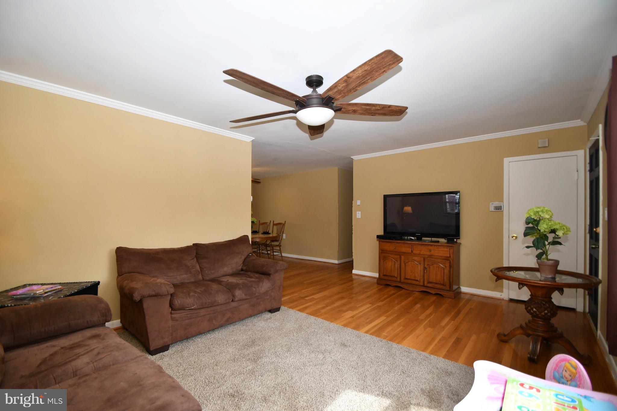 6102 Chanceford Road Baltimore, MD 21228 - Photo 3 of 30 a living room with furniture and a flat screen tv