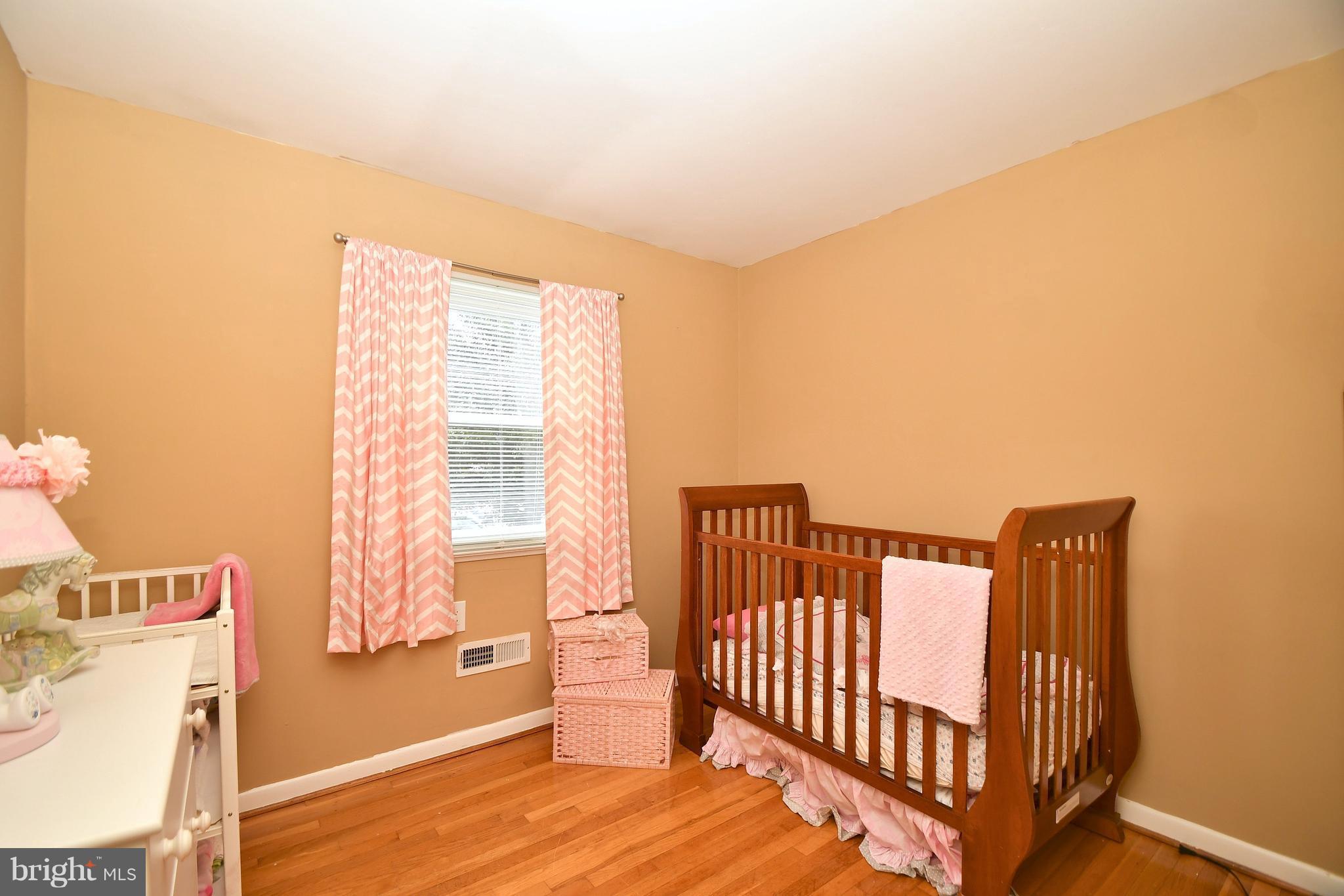 6102 Chanceford Road Baltimore, MD 21228 - Photo 22 of 30 a view of a room with a window and wooden floor