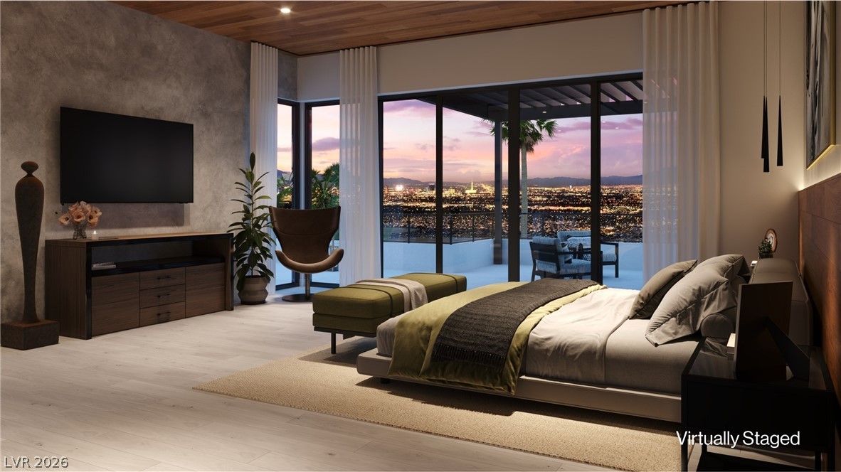 507 Overlook Rim Drive Henderson, NV 89012 - Photo 12 of 22 City lights stretch endlessly from this bedroom's floor-to-ceiling glass doors, offering an unparalleled panoramic vista.