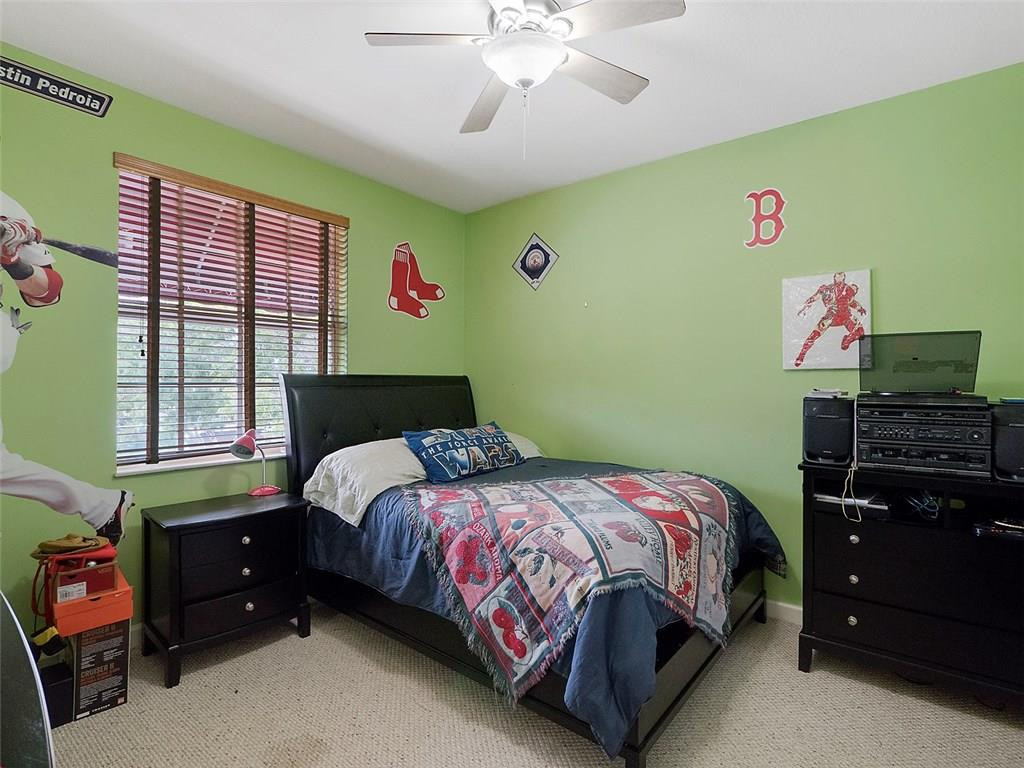 12980 Southwest 52nd Street Miramar, FL 33027 - Photo 11 of 17 a bedroom with a bed and a window