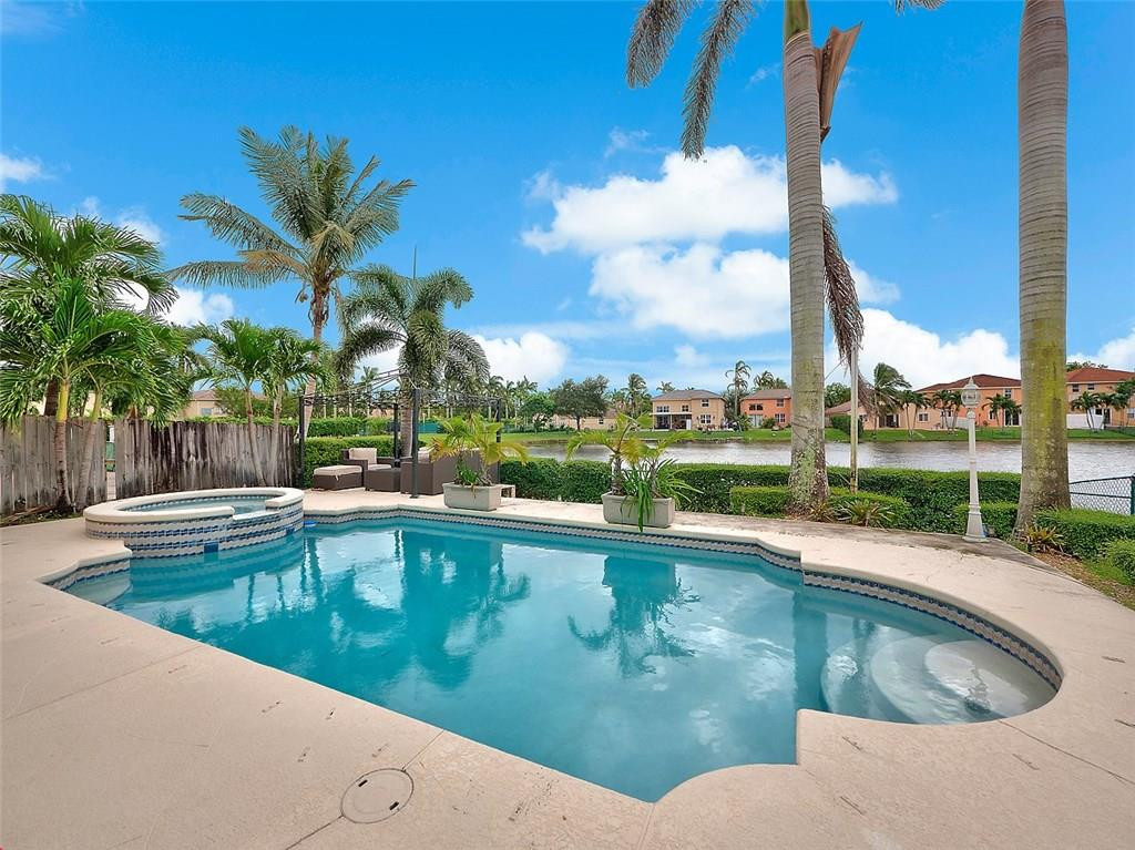 12980 Southwest 52nd Street Miramar, FL 33027 - Photo 2 of 17 a view of a swimming pool and a terrace