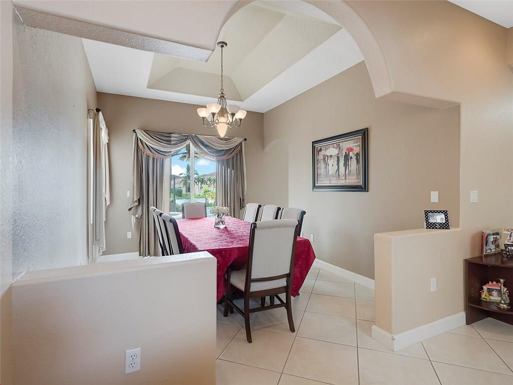 12980 Southwest 52nd Street Miramar, FL 33027 - Photo 4 of 17 a view of a dining room with furniture and a chandelier