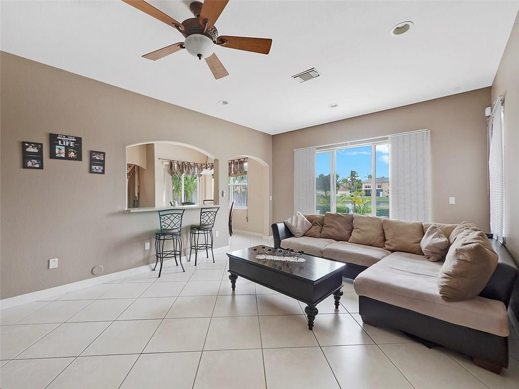 12980 Southwest 52nd Street Miramar, FL 33027 - Photo 5 of 17 a living room with furniture and a large window