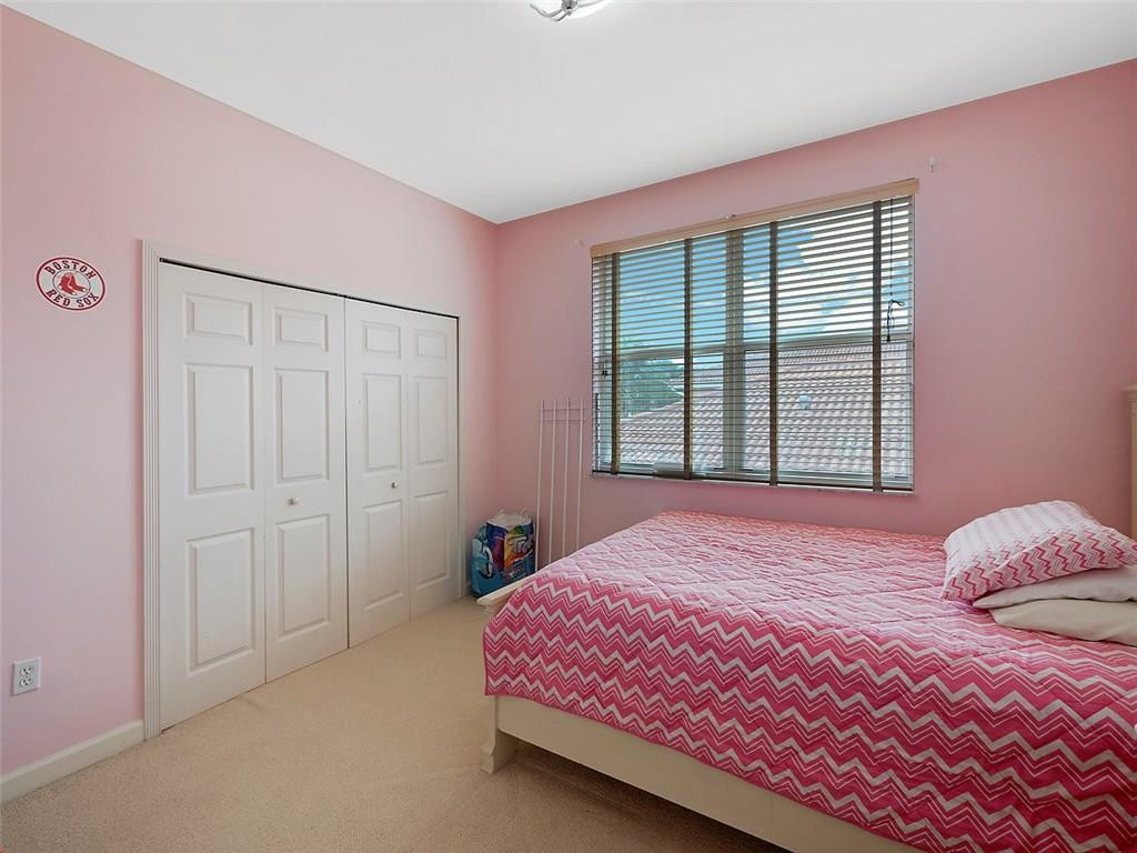12980 Southwest 52nd Street Miramar, FL 33027 - Photo 10 of 17 a bedroom with a bed and a window