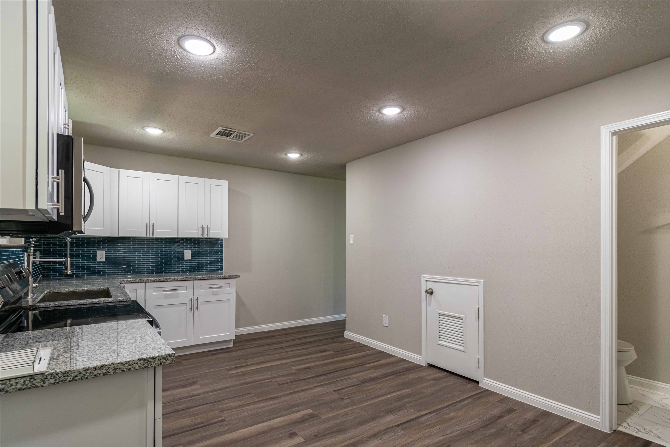 7921 Cook Road Houston, TX 77072 - Photo 3 of 19 a kitchen with a sink and wooden floor