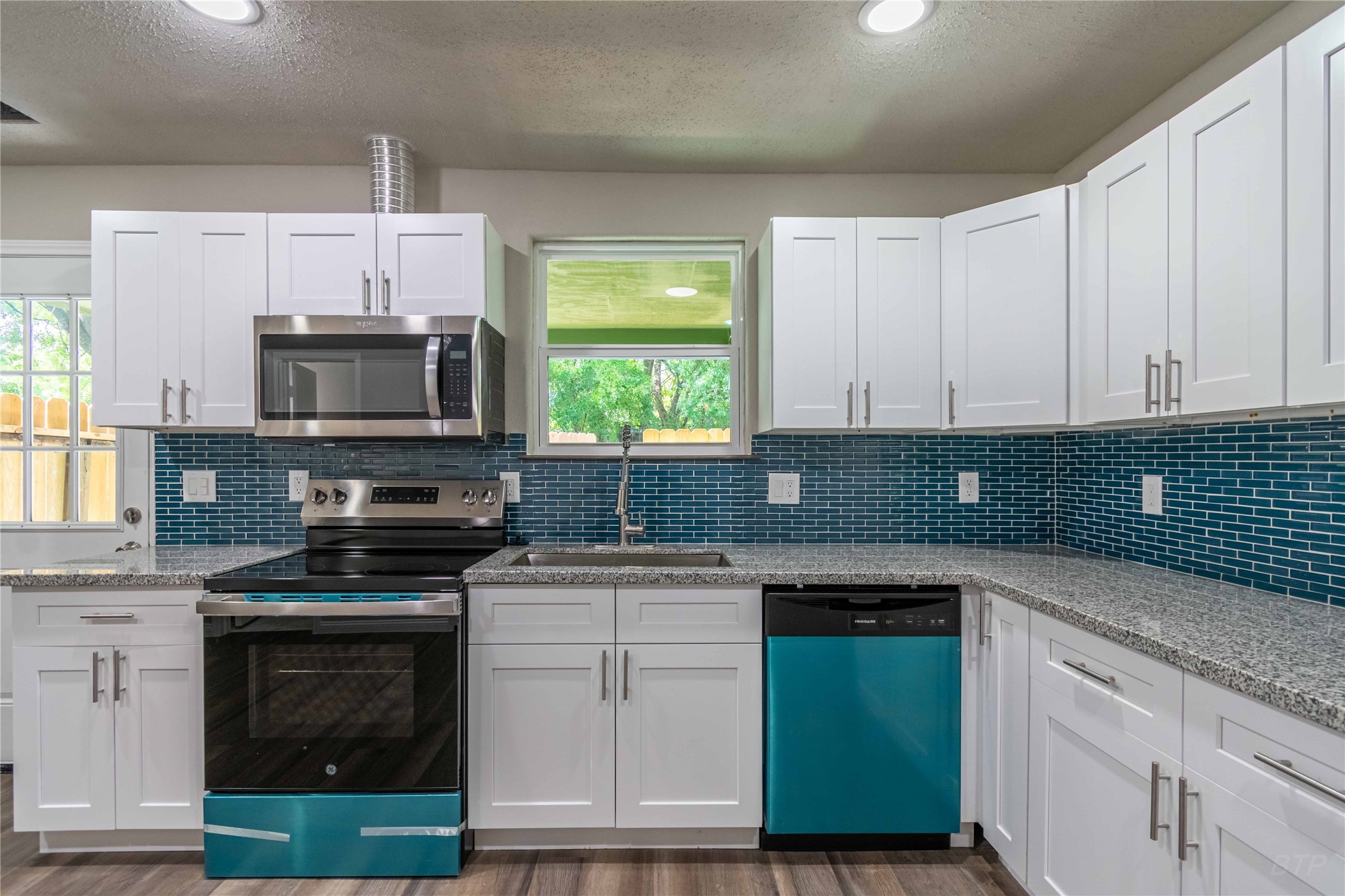7921 Cook Road Houston, TX 77072 - Photo 4 of 19 a kitchen with granite countertop a sink cabinets and stainless steel appliances