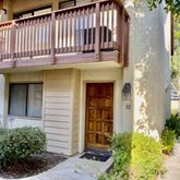 a view of a house with a small yard and plants