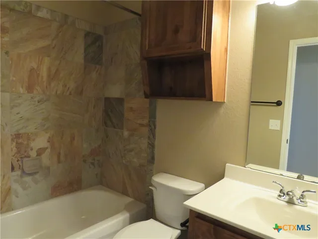 a bathroom with a sink a toilet and bathtub