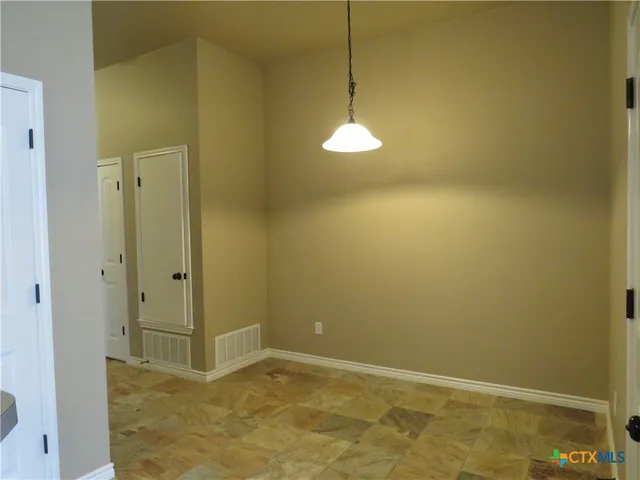 a view of a hallway with wooden shelves