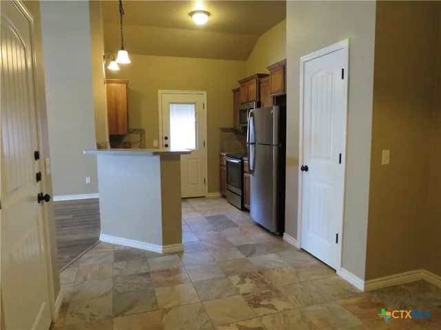 a kitchen with a refrigerator and a sink