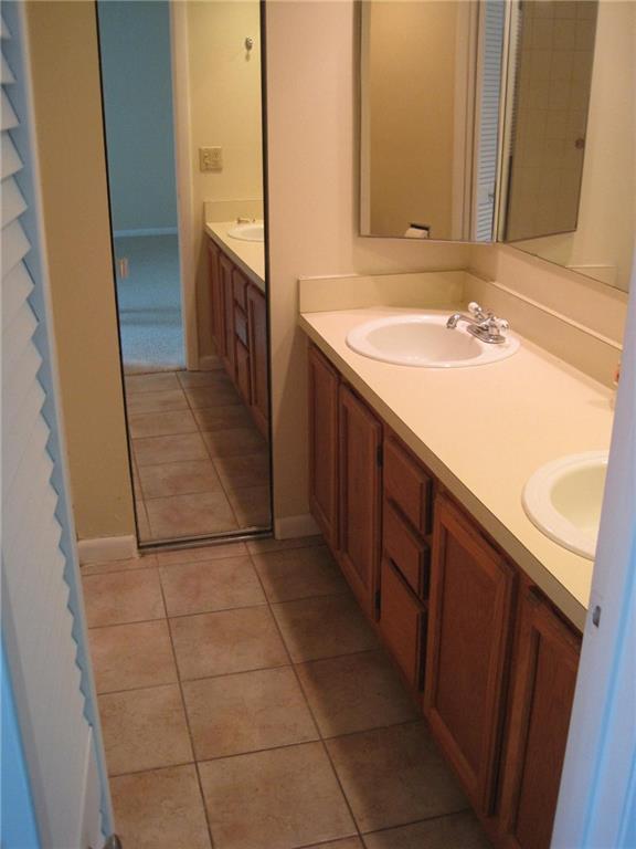 5768 Southeast Windsong Lane Stuart, FL 34997 - Photo 13 of 15 a bathroom with a sink and a mirror