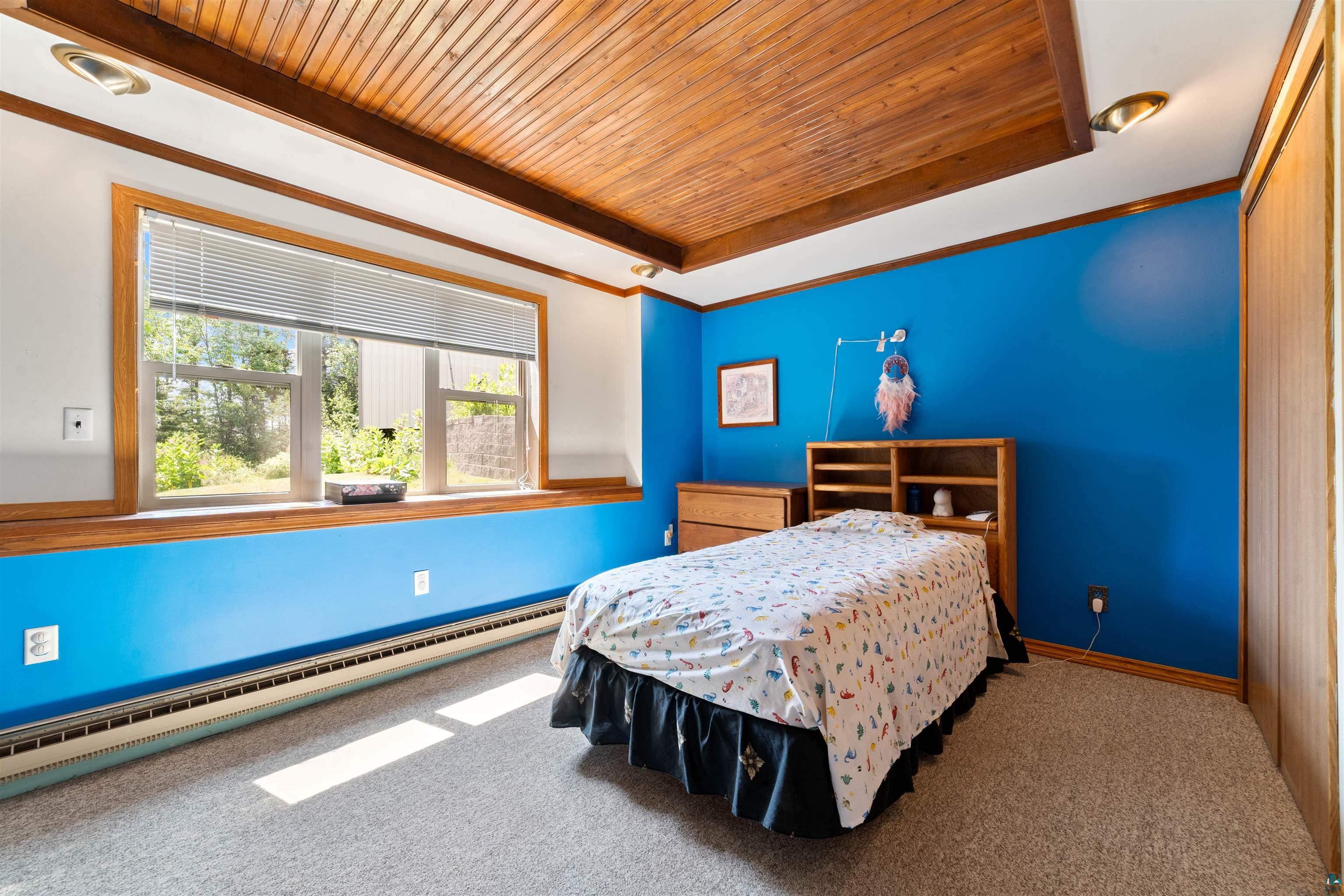 5235 Lakewood Road Duluth, MN 55804 - Photo 19 of 37 Bedroom featuring carpet flooring, wood ceiling, and a baseboard radiator