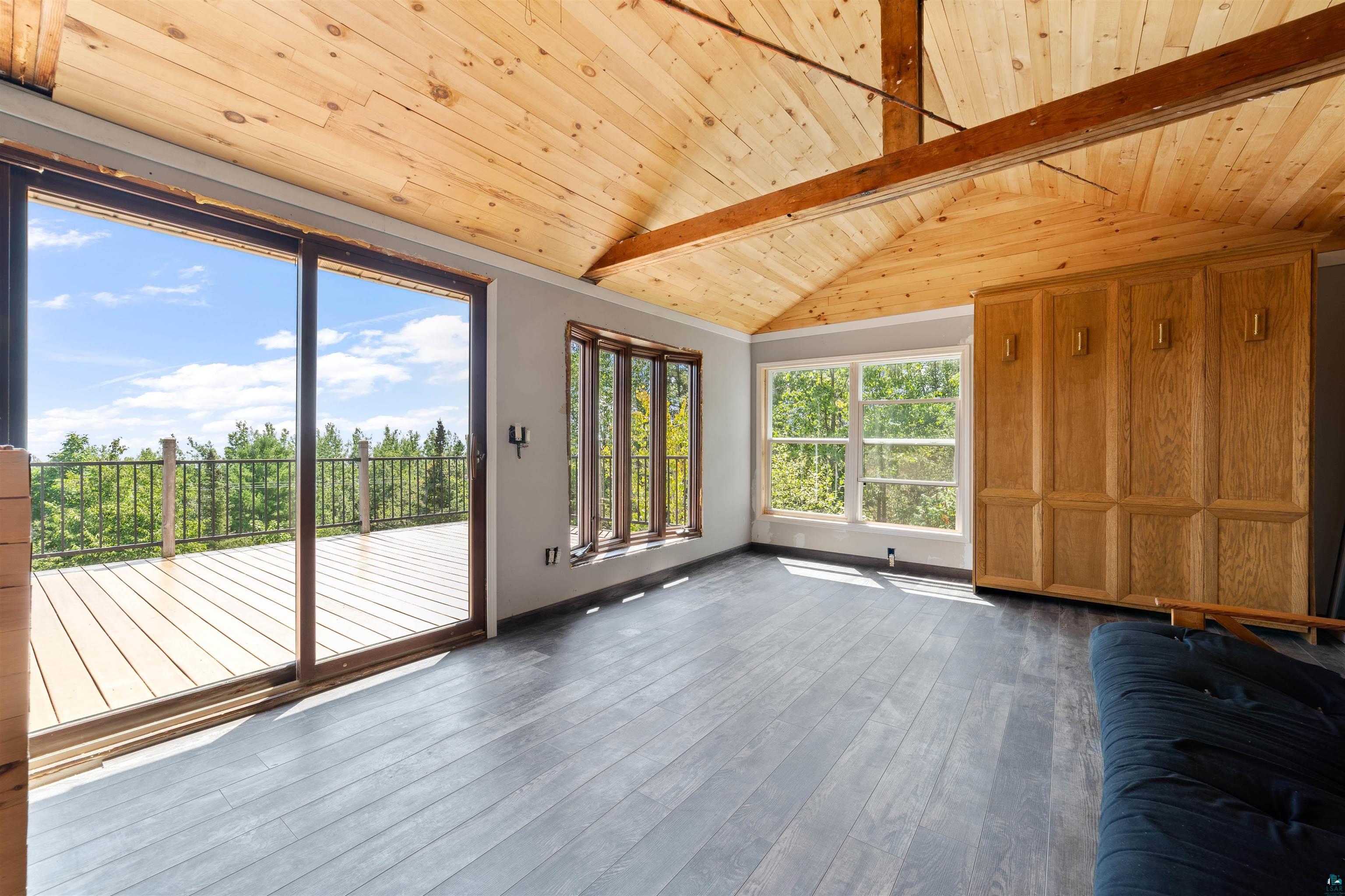5235 Lakewood Road Duluth, MN 55804 - Photo 27 of 37 Interior space with vaulted ceiling with beams, dark hardwood / wood-style flooring, and wooden ceiling