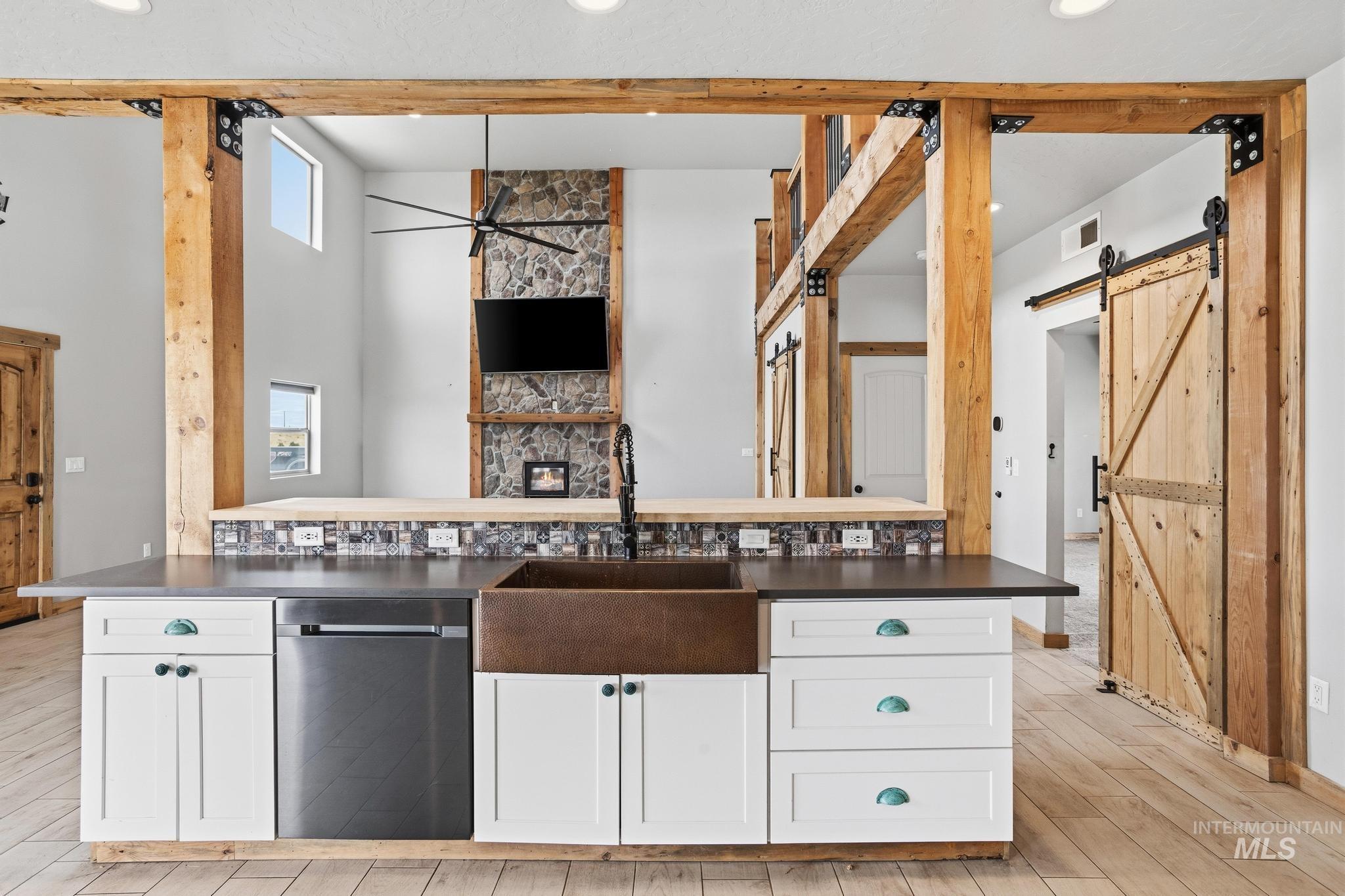 870 Desert Wind Road Boise, ID 83716 - Photo 9 of 50 Kitchen featuring white shaker cabinetry, dark countertops, a tile backsplash with decorative mosaic inlay, a stainless steel range, and a copper-toned range hood