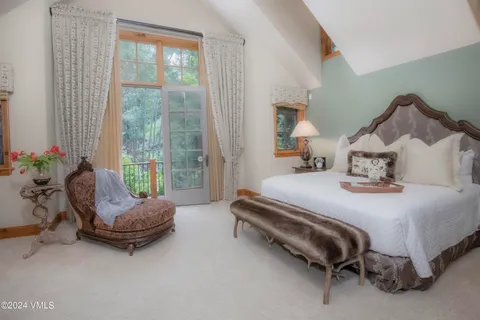 a spacious bedroom with a bed and a large window