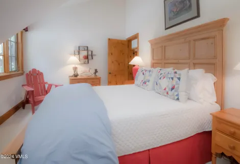 a bed room with a bed and a chair