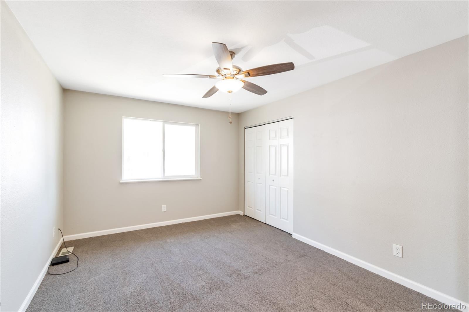 13488 East 13th Place Aurora, CO 80011 - Photo 13 of 15 a view of room with a ceiling fan and a window