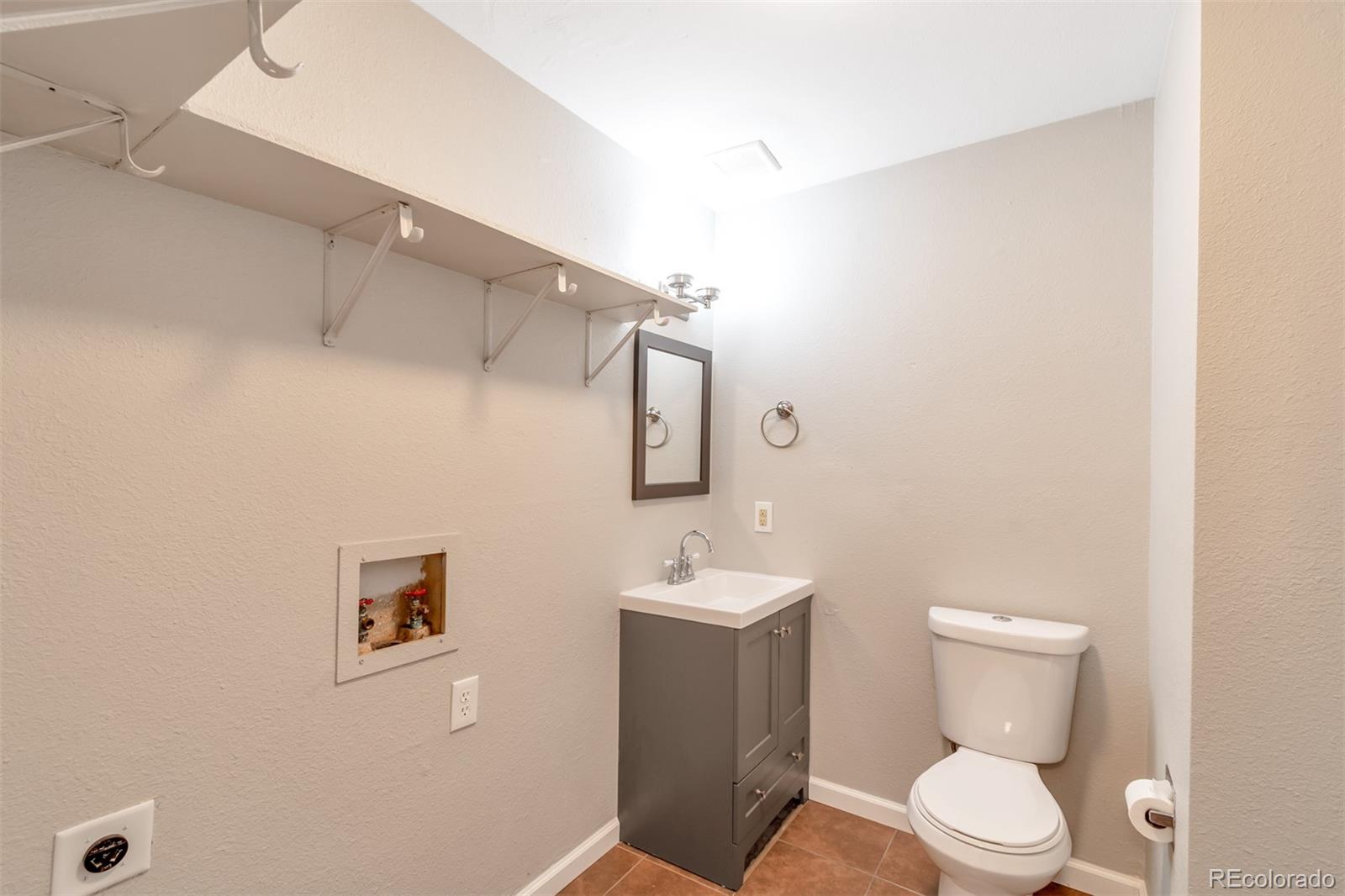 13488 East 13th Place Aurora, CO 80011 - Photo 4 of 15 a bathroom with a toilet sink and mirror