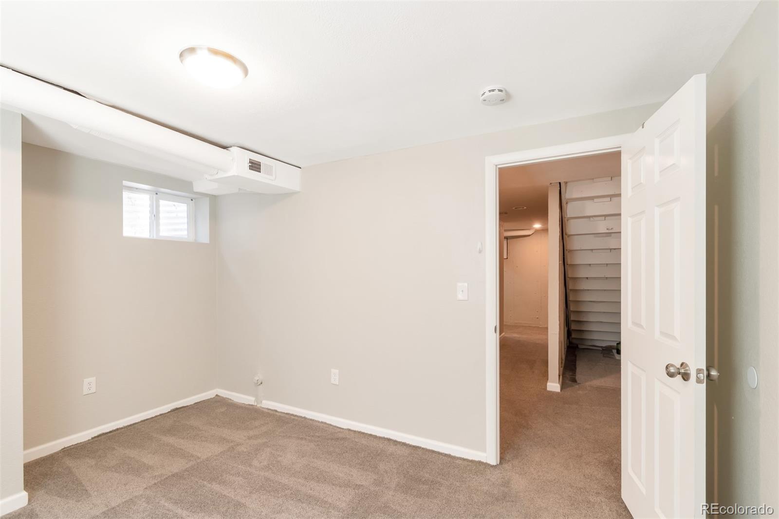 13488 East 13th Place Aurora, CO 80011 - Photo 10 of 15 a view of an empty room and a windows