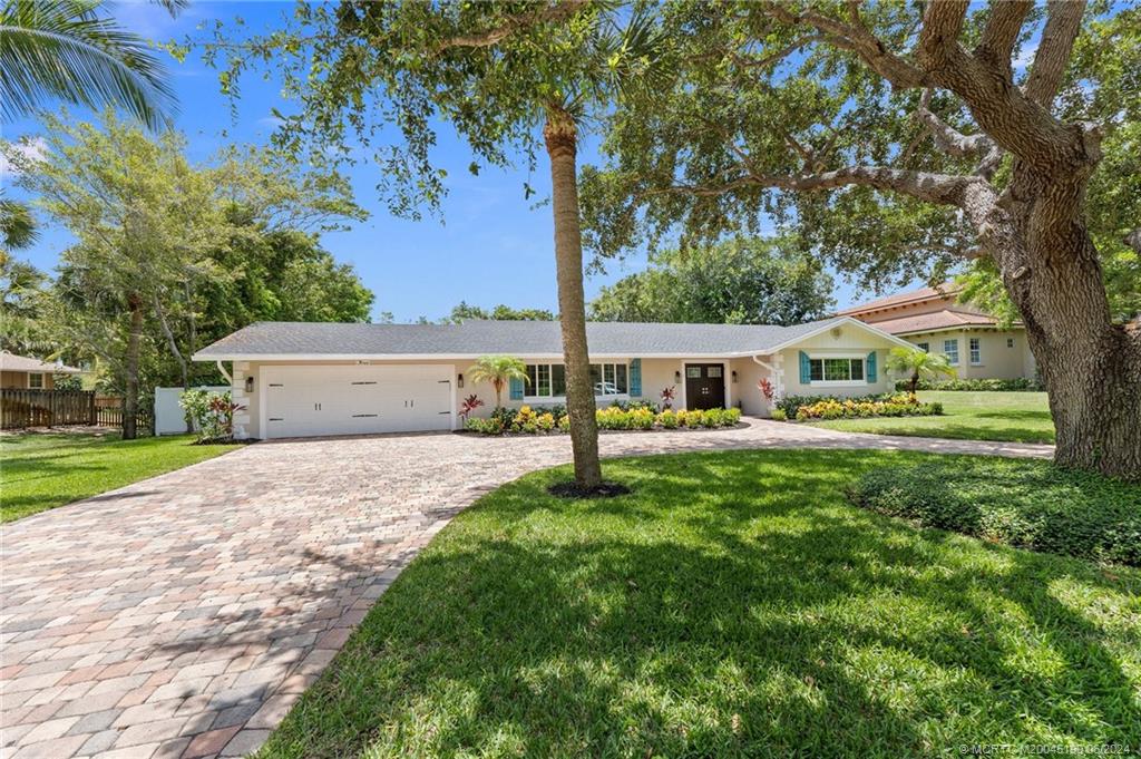 a front view of house with yard and green space
