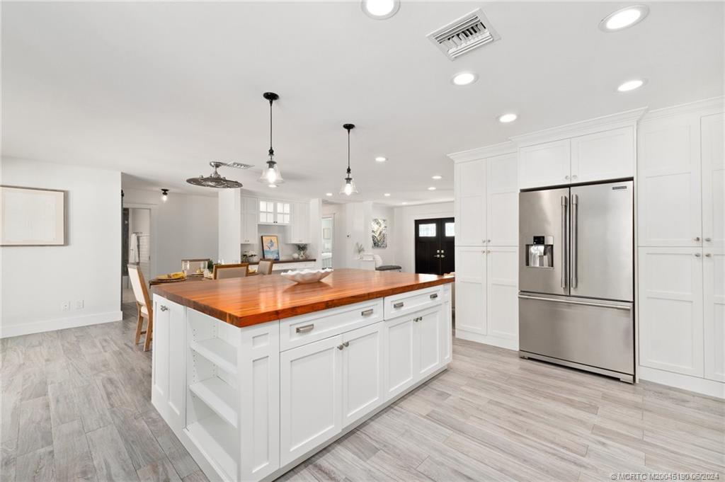 3 Mandalay Road Stuart, FL 34996 - Photo 13 of 65 a kitchen with stainless steel appliances granite countertop a sink and a refrigerator