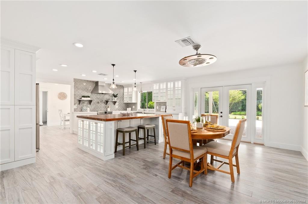 3 Mandalay Road Stuart, FL 34996 - Photo 17 of 65 a view of a dining room with furniture window and wooden floor
