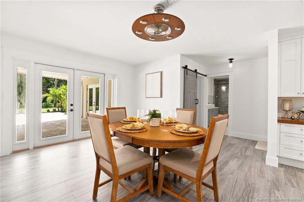 3 Mandalay Road Stuart, FL 34996 - Photo 18 of 65 a view of a dining room with furniture and wooden floor