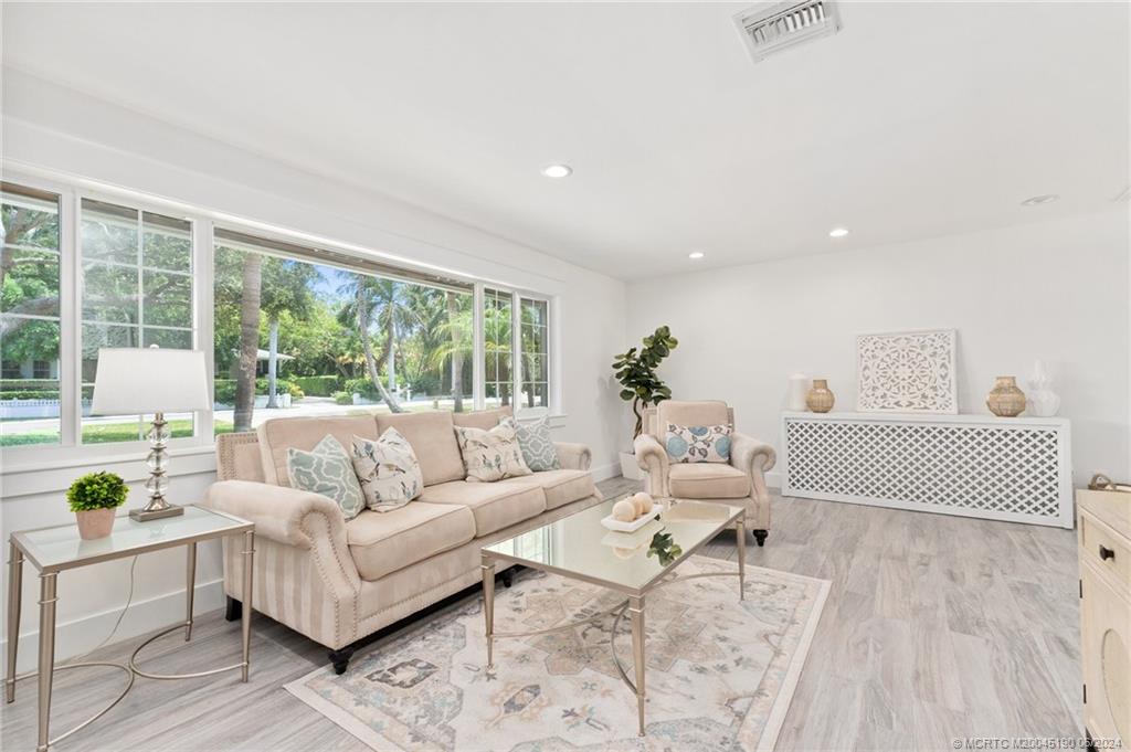3 Mandalay Road Stuart, FL 34996 - Photo 22 of 65 a living room with furniture and a large window