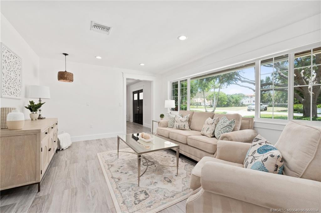 3 Mandalay Road Stuart, FL 34996 - Photo 23 of 65 a living room with furniture and a large window