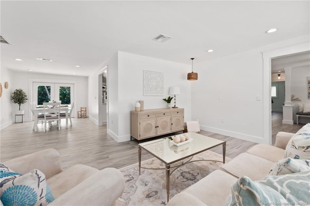 3 Mandalay Road Stuart, FL 34996 - Photo 24 of 65 a living room with furniture and wooden floor