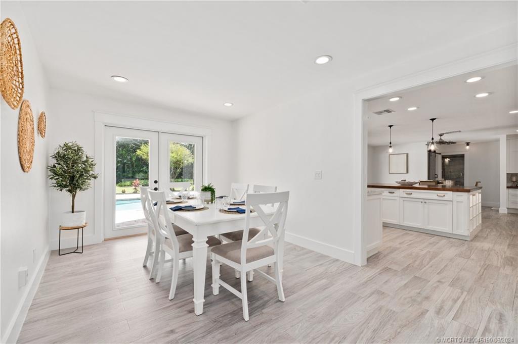 3 Mandalay Road Stuart, FL 34996 - Photo 25 of 65 a view of a dining room with furniture and wooden floor