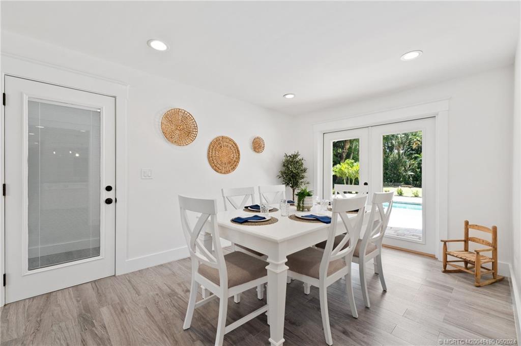 3 Mandalay Road Stuart, FL 34996 - Photo 26 of 65 a dining room with wooden floor and breakfast area