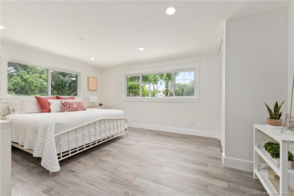 3 Mandalay Road Stuart, FL 34996 - Photo 36 of 65 a bedroom with a bed and a potted plant