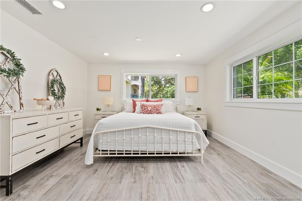 3 Mandalay Road Stuart, FL 34996 - Photo 37 of 65 a bedroom with a large bed and a dresser