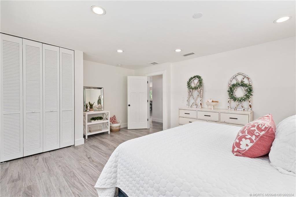 3 Mandalay Road Stuart, FL 34996 - Photo 38 of 65 a spacious bedroom with a bed and a window