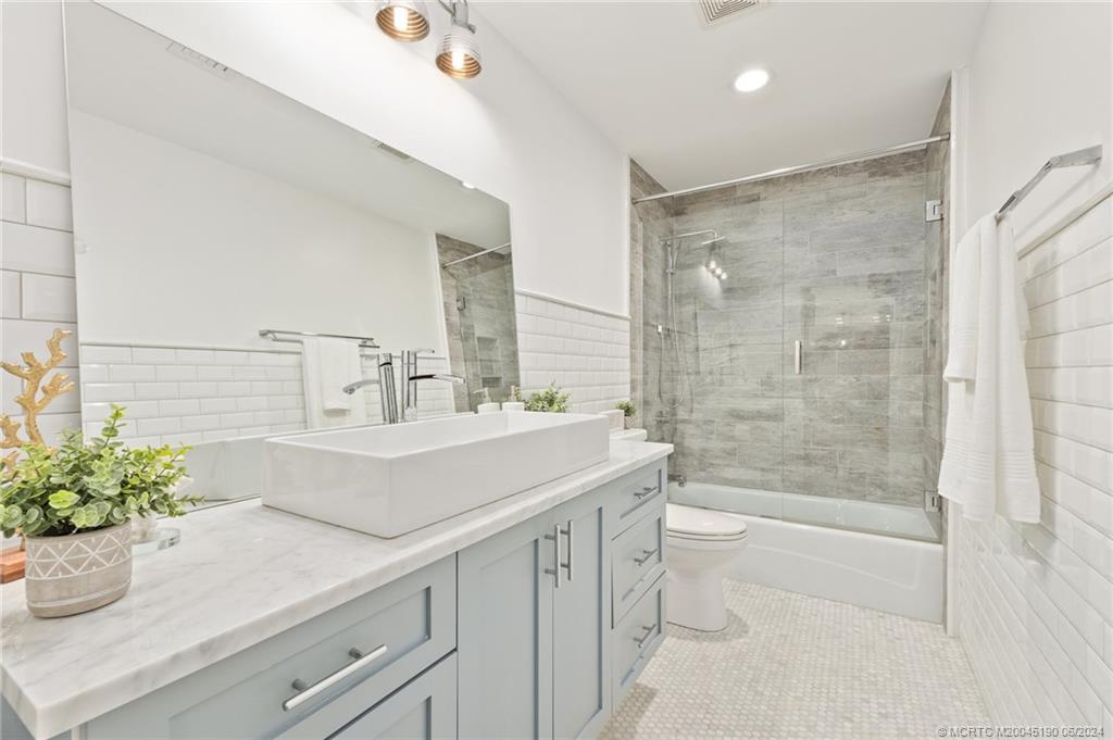 3 Mandalay Road Stuart, FL 34996 - Photo 39 of 65 a bathroom with a sink a toilet and shower