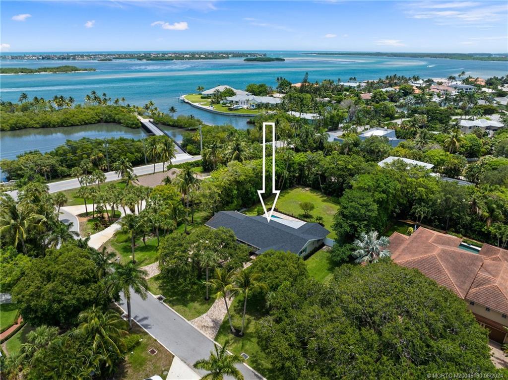 3 Mandalay Road Stuart, FL 34996 - Photo 4 of 65 an aerial view of a house with a garden and lake view