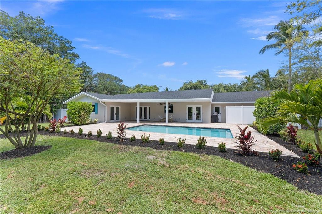 3 Mandalay Road Stuart, FL 34996 - Photo 51 of 65 a front view of a house with a garden