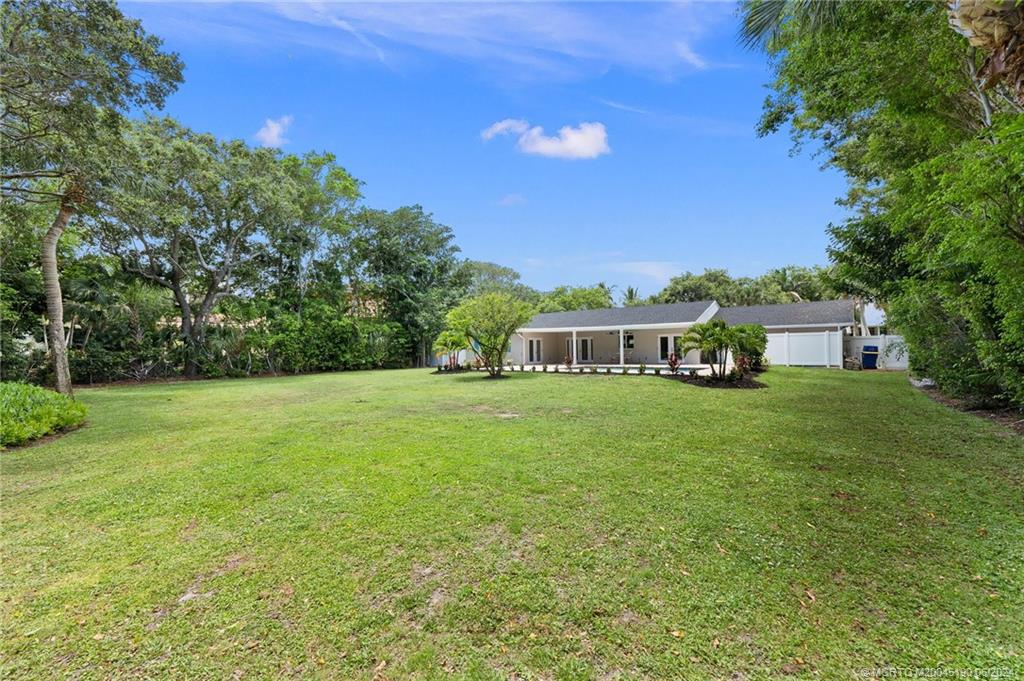 3 Mandalay Road Stuart, FL 34996 - Photo 54 of 65 a front view of a house with a garden